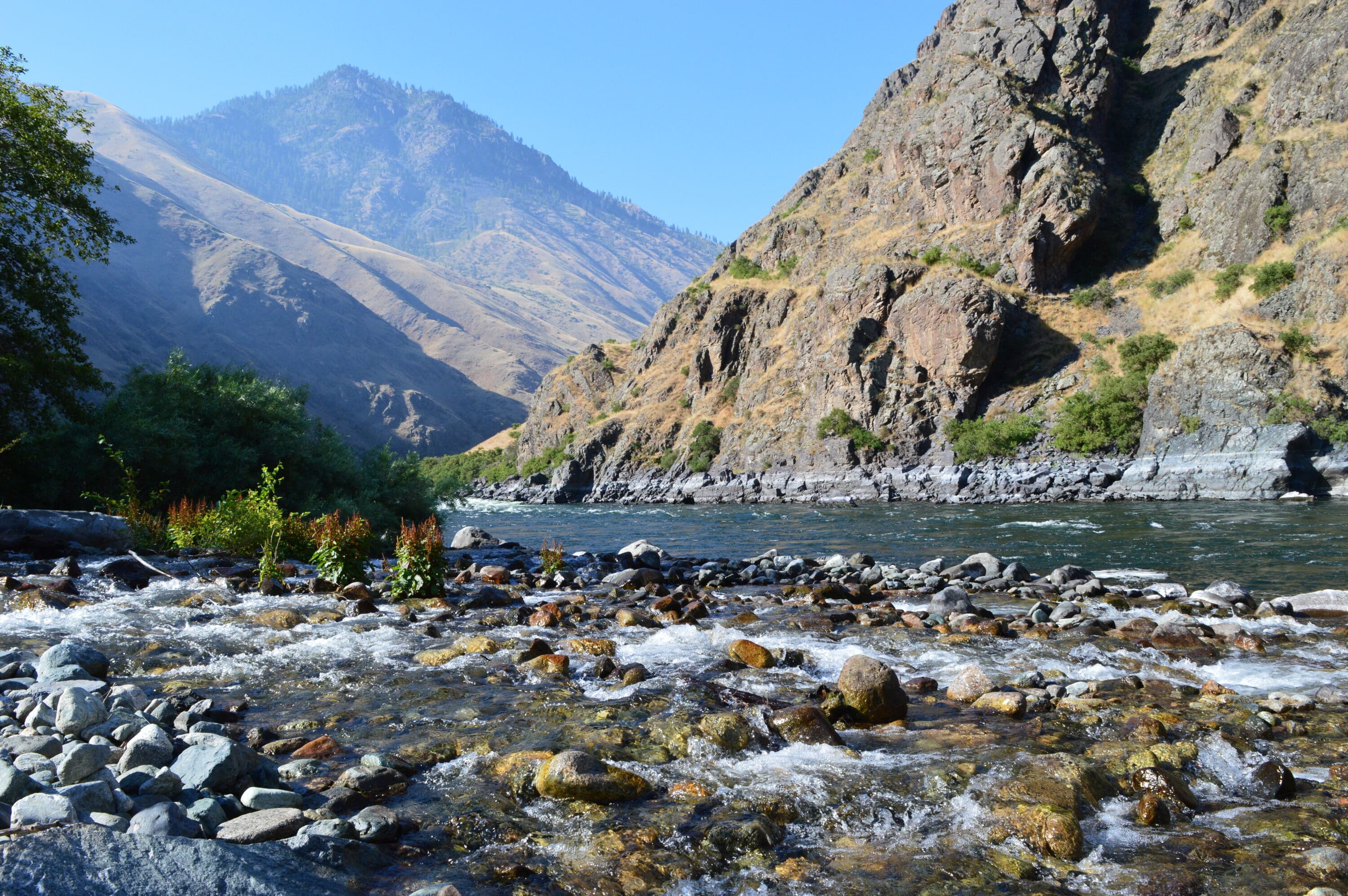 River view of stunning canyon walls and blue skies above.